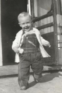 Baby Lee in jeans coming out of door